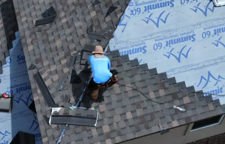 Greater Austin Roofing in Austin, Texas - Roofer installing shingles on a house roof